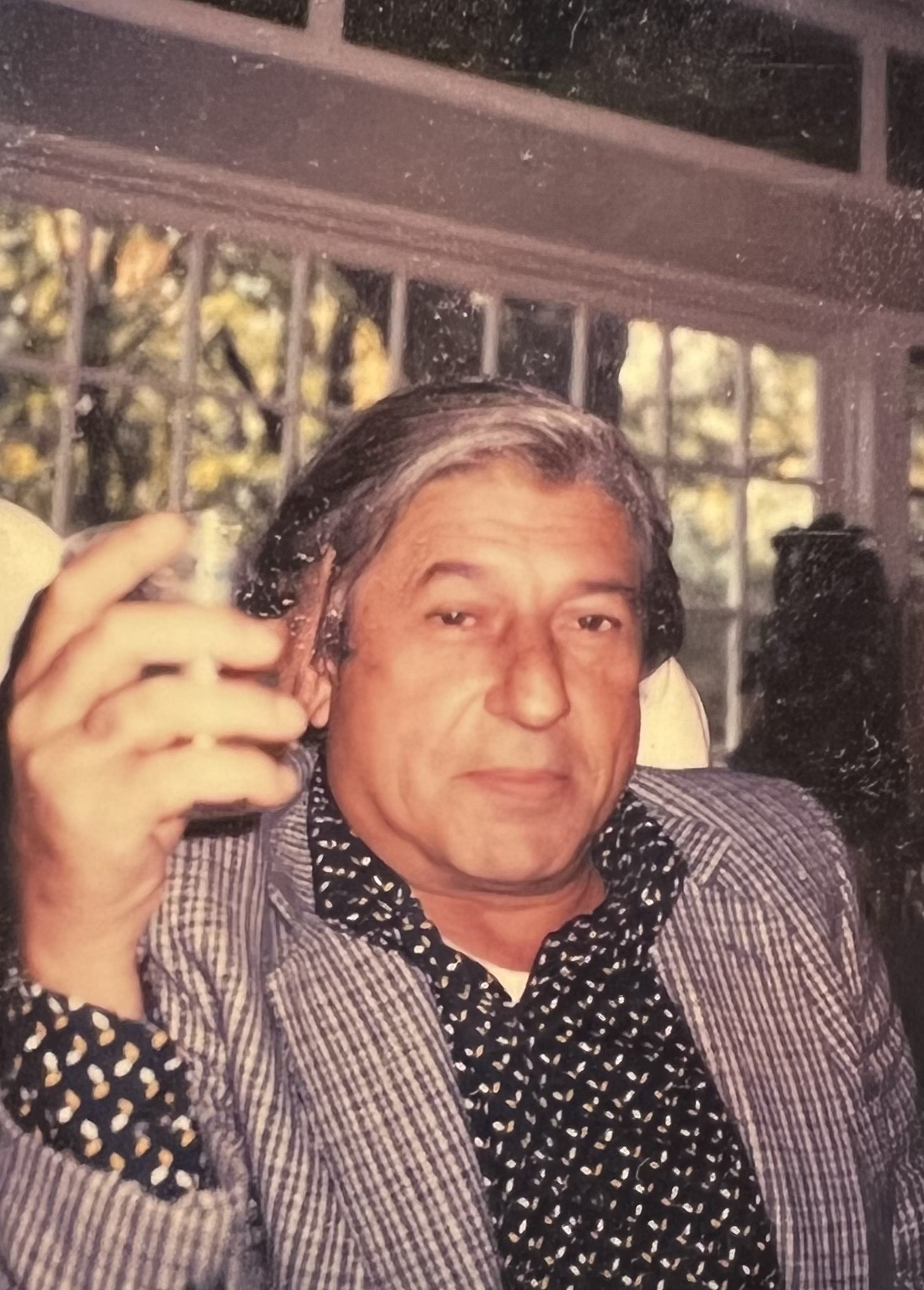 Photo of Walter Ferro holding a glass